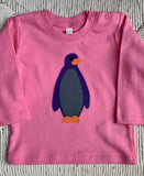 Long sleeved bubblegum pink organic cotton t-shirt for babies with applique penguin on the front. isabee