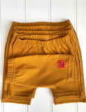 Baby shorts in fine stripe yellow - soft jersey cotton. Designed to be worn over a nappy. isabee.co.uk