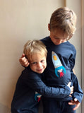 Rocket - Two boys each wearing a navy blue, long-sleeved organic cotton t-shirt for kids with hand applique rocket on the front. - isabee.co.uk