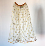 Gold tulle shirt with metallic gold stars and gold satin trim at the waist and hem. Easy wear elasticated waist. Available in three sizes for kids - short (age 3.5+ years/ 35 cm), medium (age 4.5+ years/ 43 cm length) and long (age 6+ years/ 60 cm length). A perfect addition to the dressing-up box. Also available in Silver and Red. Handmade in the UK by Isabee.