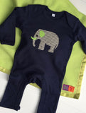 Handmade fleece baby blanket in Apple Green with matching satin trim. Shown with Baby Elephant navy blue sleepsuit for babies - isabee.co.uk