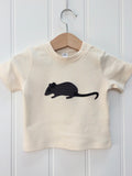 Natural white organic cotton, short-sleeved t-shirt on a hanger with a hand applique mouse on the front. The mouse is made of fine stripe grey cotton melange, with black eye, ears and tail. Designed and hand made in the Isabee London studio. Available in four sizes for babies (3 -24 months). Includes Isabee easy-wear neck with poppers. Also available for ages 2 to 5 years.