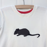 Close up of natural white organic cotton, short-sleeved t-shirt on a hanger with a hand applique mouse on the front. The mouse is made of fine stripe grey cotton melange, with black eye, ears and tail. The inside neck has a stylish red trim. Designed and hand made in the Isabee London studio. Available in two sizes for kids (2-5 years of age). Baby Mouse is available for age 3-24 months.