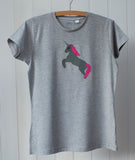 Adult's grey melange t-shirt with hand applique unicorn on the front, on a hanger against a white background. The unicorn in darker grey is rearing on its hind legs with a reflective horn and pink mane and tail. - isabee.co.uk